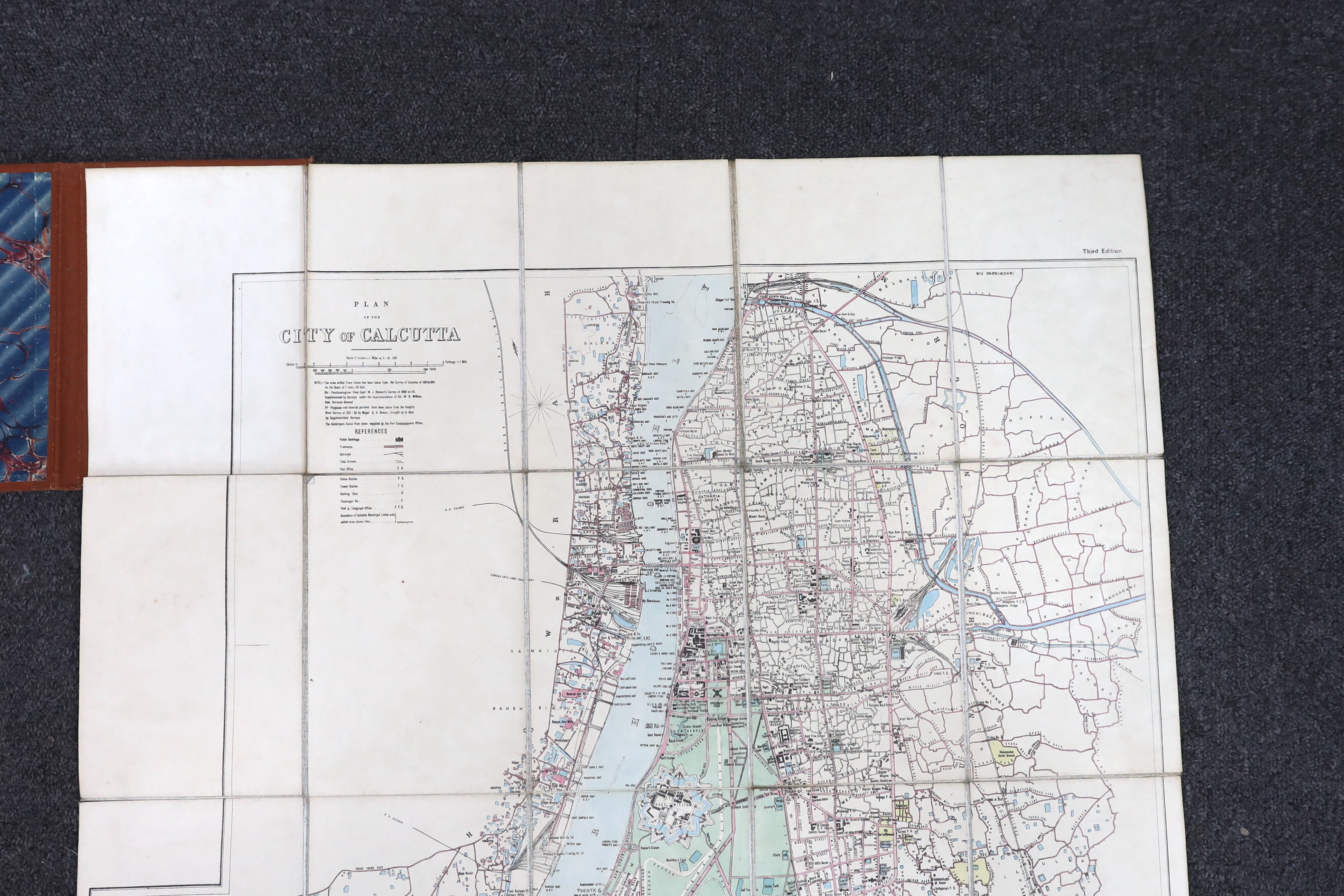 Plan of the City of Calcutta ... 3rd edition. coloured and folded on linen, opens to approx. 60x 55cm. within ruled borders, engraved title and key, scale: 3ins. to mile, contained within gilt lettered cloth covers. Surv